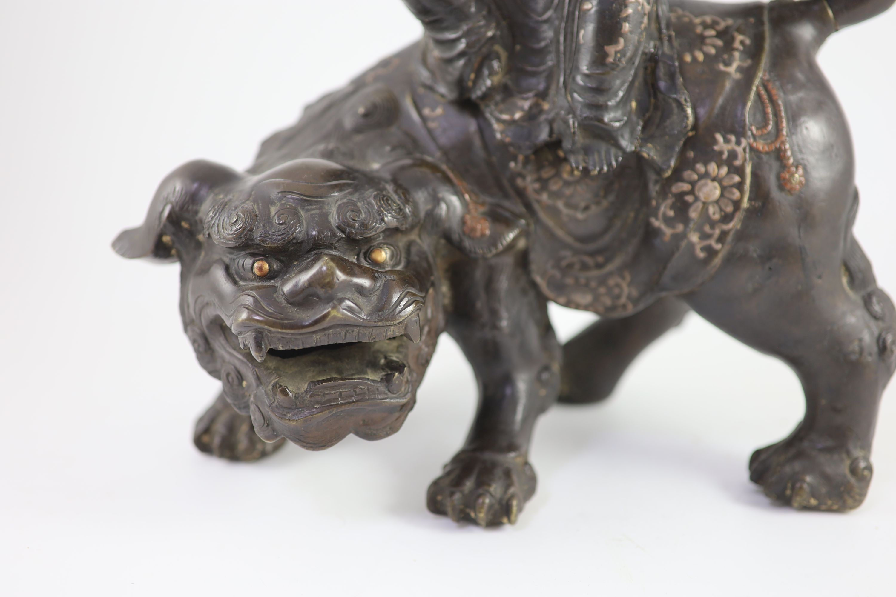 A large Chinese/Japanese bronze censer modelled as Wenshu riding a lion-dog, 17th/18th century 40 cm high, 35 cm long